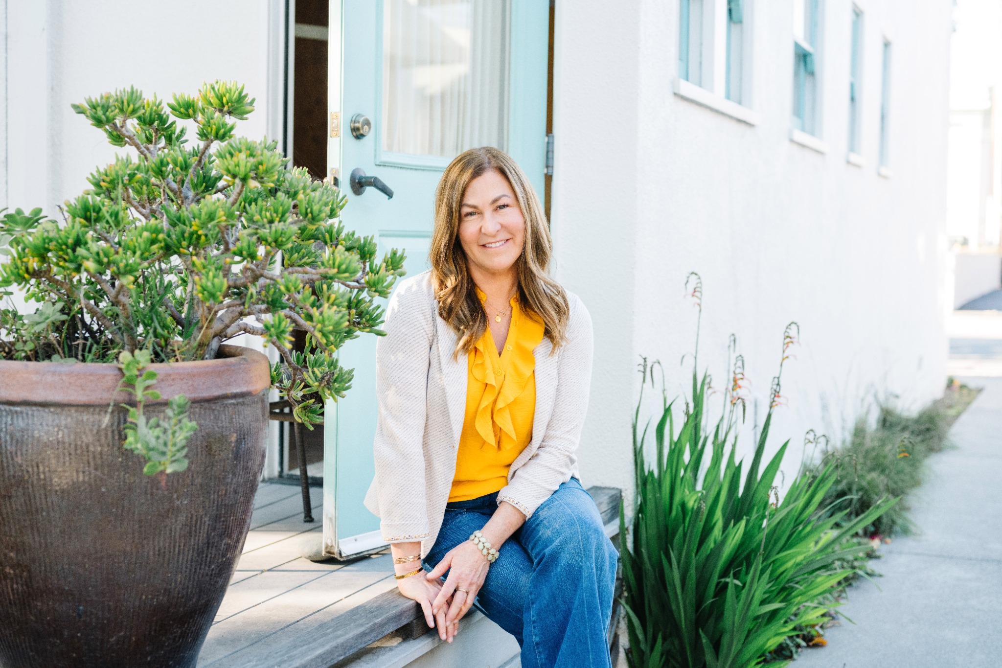 Nancy Thomas seated outside her office